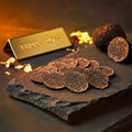 Thin fresh Tuber melanosporum slices showing natural marbling and irregular shapes